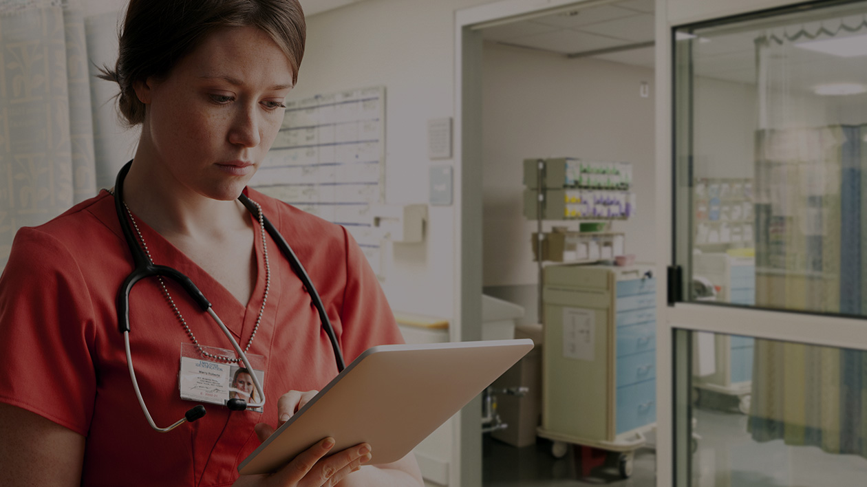 Medical worker using a tablet and wearing Filium-activated apparel