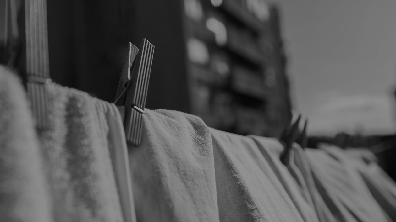 Black and white photo of a clothesline with linens