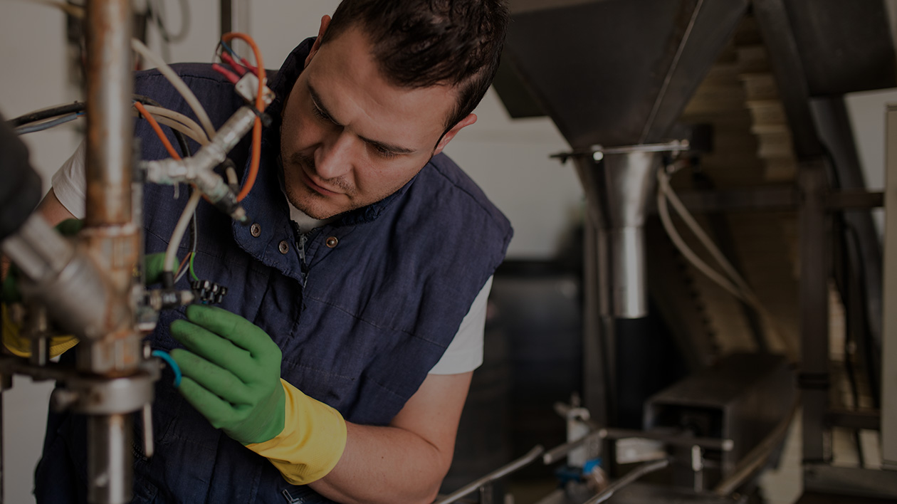 Technician working on an electrical project, wearing Filium-activated work wear